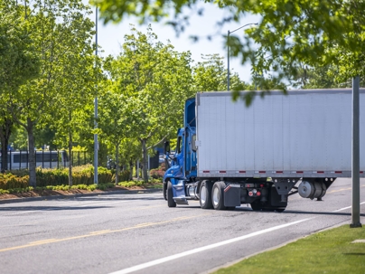 Semi-truck making a right turn on an empty street during the day