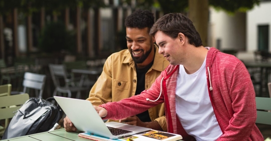 Man with disability discussing work with corworker