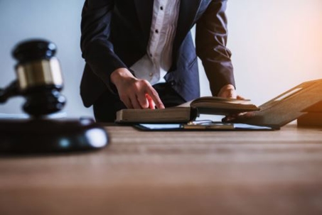 attorney pointing to book on desk