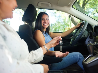 side view of teenage girl and her mother in the car