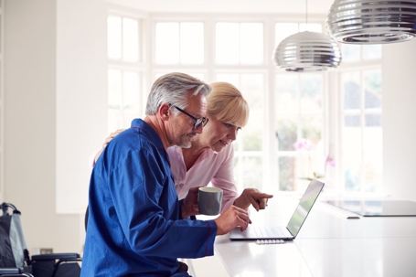 Older couple looking up information on laptop