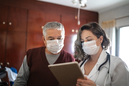 doctor and patient wearing mask during health appointment