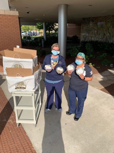 Sentara Emergency Room staff holding food brought by Kalfus & Nachman PC.