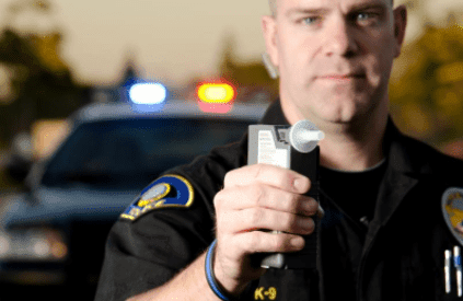 Police officer with breathalyzer 