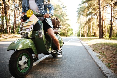 man riding on a moped